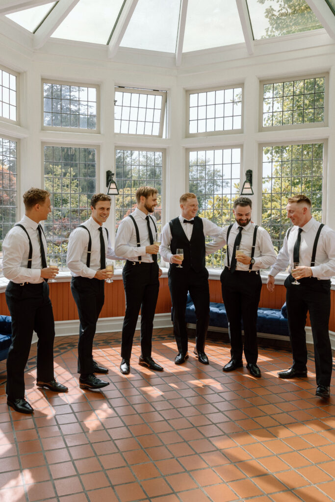 Groom and groomsmen in solarium of Cecil Green Park House Venue